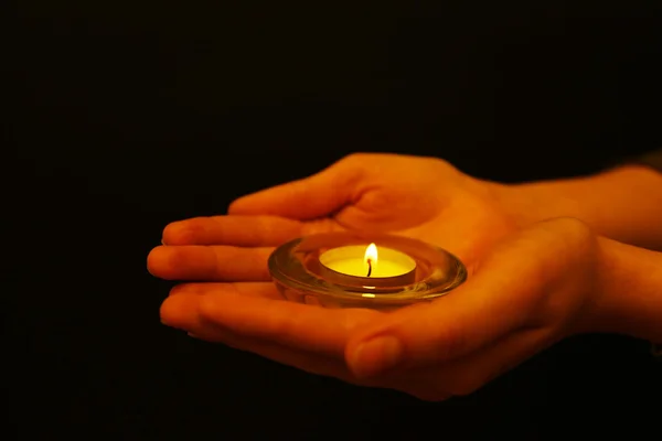 Burning candle in hands Royalty Free Stock Photos