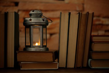Arka plan kitaplar ve dekoratif fener tablo ve tuğla duvar