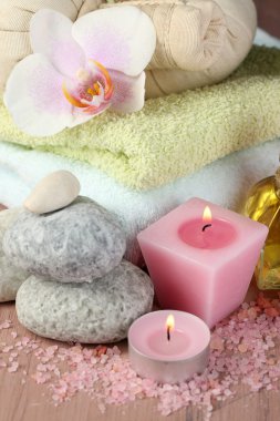 Spa uygulamaları ile renkli arka plan üzerinde ahşap masa üzerinde orkide çiçek