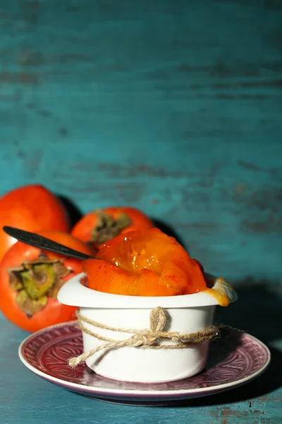 Ripe sweet persimmons, on wooden table — Stock Photo, Image