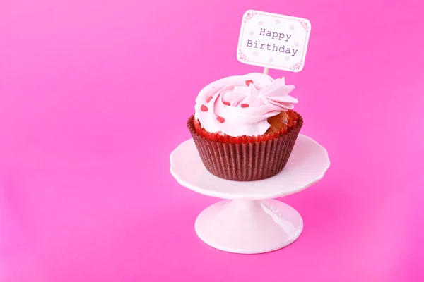 Delicious cupcake with inscription on color background — Stock Photo, Image