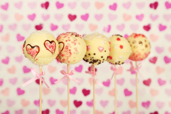 Tasty cake pops on color background — Stock Photo, Image