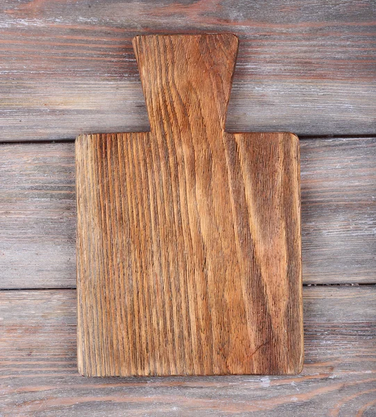 Cutting board on rustic wooden planks background — Stock Photo, Image