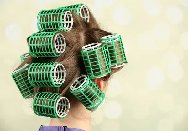 Long female hair during hair dressing with curler, close-up, on light background — Stock Photo, Image