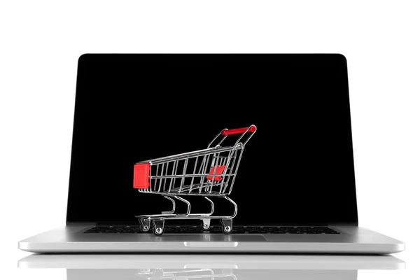 Laptop com carrinho de compras pequeno isolado no fundo branco — Fotografia de Stock