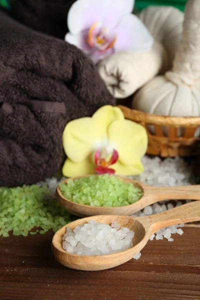 Spa uygulamaları ile renkli arka plan üzerinde ahşap masaya orkide çiçek