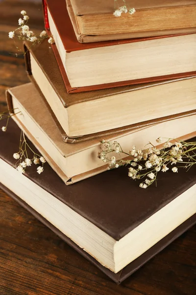 Books with dried flowers on wooden background — Stock Photo, Image