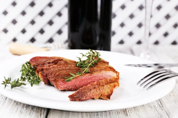 Steak with bottle of wine — Stock Photo, Image