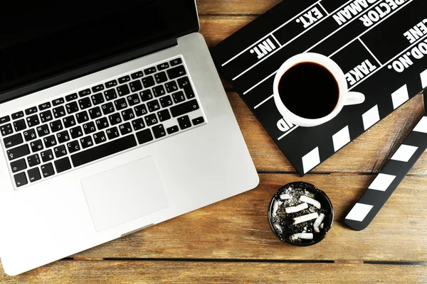 Movie clapper with laptop and coffee — Stock Photo, Image