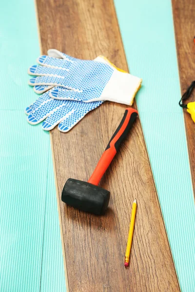 Carpenter tools on laminate floor — Stock Photo, Image