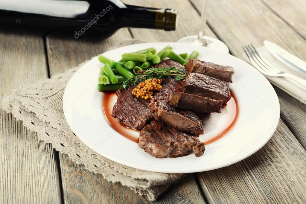 Steak with bottle of wine