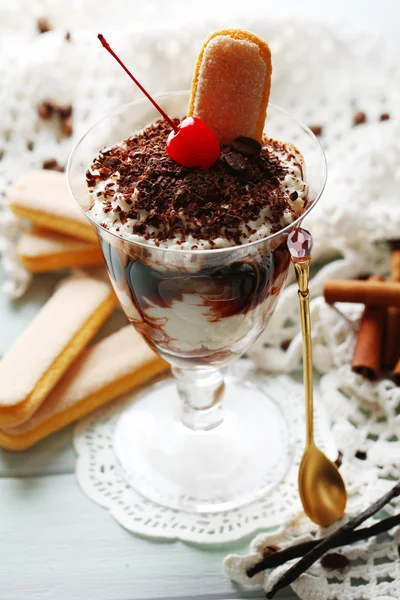 Tasty tiramisu dessert in glass, on wooden background — Stock Photo, Image