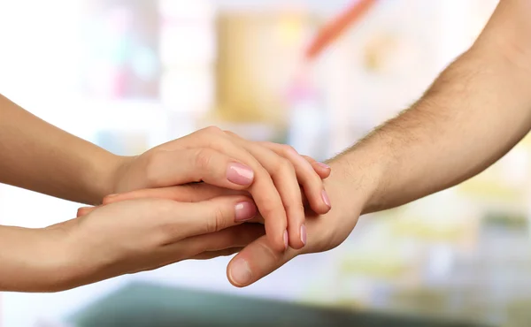 Male and female hands on light background — Stock Photo, Image