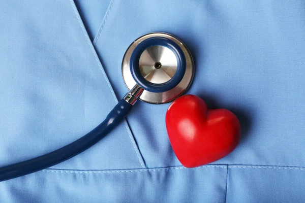 Stethoscope with heart on suit background, close-up — Stock Photo, Image