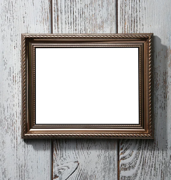 Golden photo frame on color wooden background — Stock Photo, Image