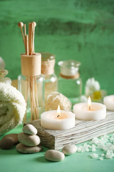 Composition of spa treatment, candles in bowl with water on wooden background — Stock Photo, Image