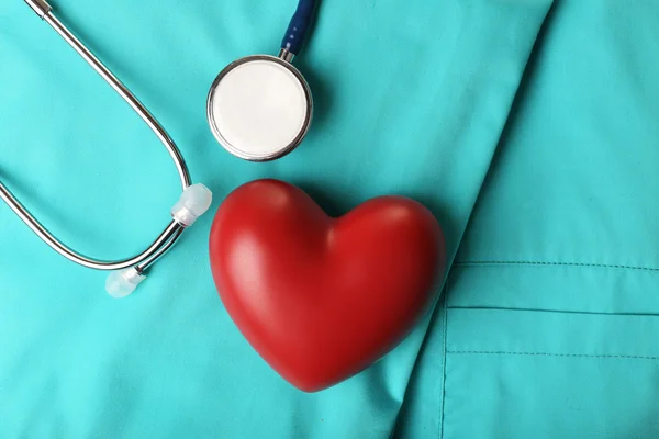 Stethoscope with heart on suit background, close-up — Stock Photo, Image