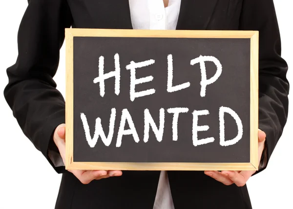 Young businesswoman holding blackboard with Help Wanted text on it — Stock Photo, Image