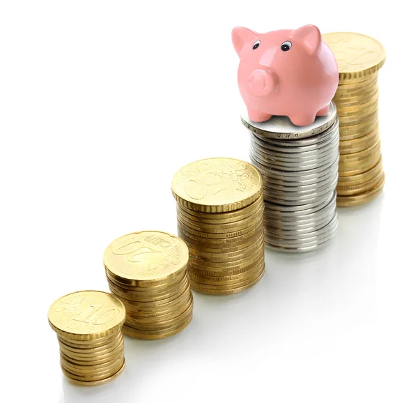 Piggy bank standing on stack of coins isolated on white — Stock Photo, Image