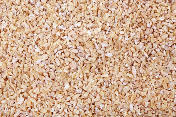 背景として小麦をひき割り穀物 — ストック写真
