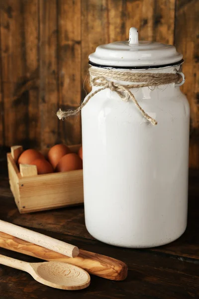 牛奶可以用鸡蛋和勺子在仿古木制背景 — 图库照片