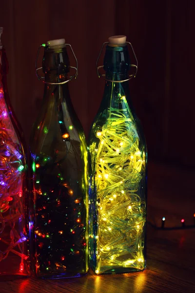 Christmas lights in bottles — Stock Photo, Image