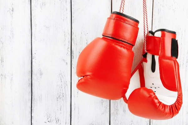 Pair of boxing gloves on color wooden background — Stock Photo, Image