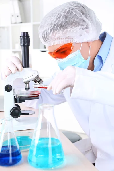 Male scientist using microscope in laboratory Royalty Free Stock Images