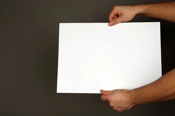 Blank paper in male hands — Stock Photo, Image