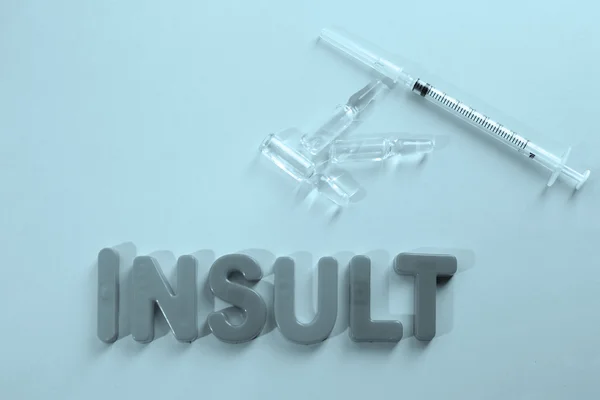 Medicamentos com palavra Insulto sobre fundo turquesa — Fotografia de Stock