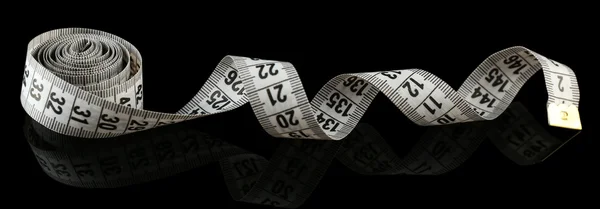 Measuring tape on black background — Stock Photo, Image