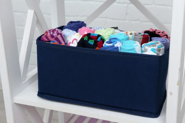 Socks in textile box on shelf — Stock Photo, Image