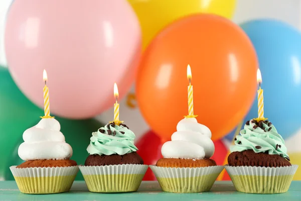 Delicious birthday cupcakes on table on bright background — Stock Photo, Image