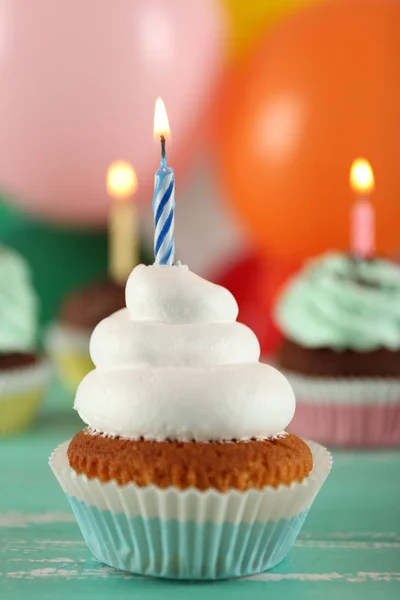 Смачні кекси на день народження на столі на яскравому фоні — стокове фото