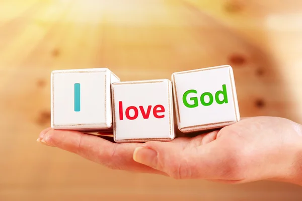 I love God text spelled in cubes on wooden background — Stock Photo, Image