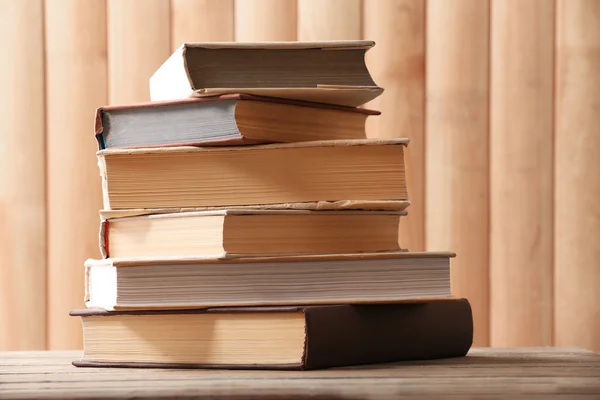 Stack of books on wooden planks background — Zdjęcie stockowe