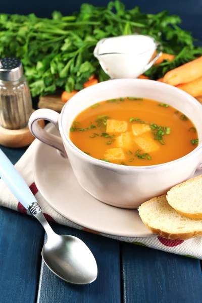 Složení s mrkvová polévka, ingredience a byliny na barevné dřevěné pozadí — Stock fotografie