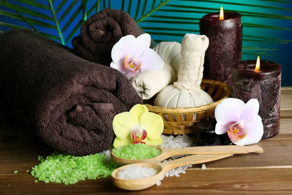 Spa-behandlingar med orkidé blomma på träbord på färgstarka bakgrund — Stockfoto