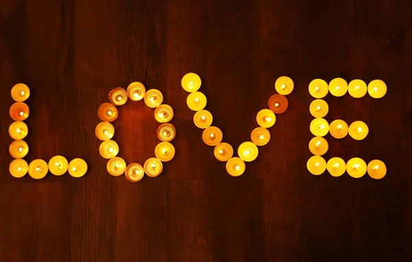 Word LOVE  burning candles — Stock Photo, Image