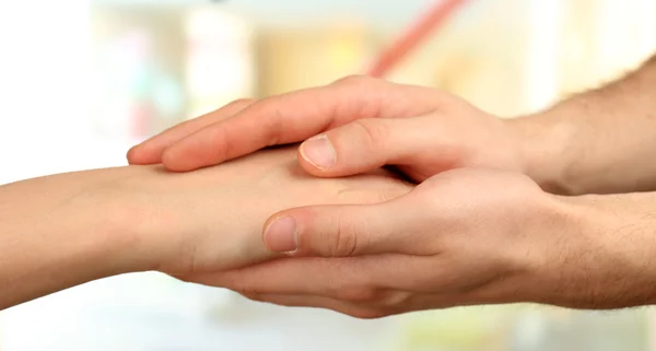 Male and female hands on light background — Stock Photo, Image