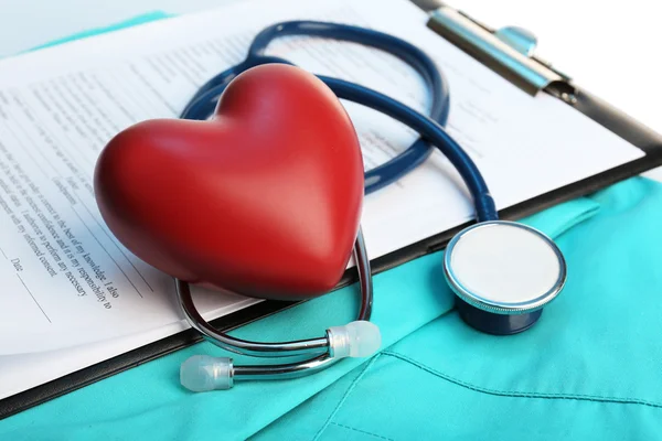 Stethoscope with heart on suit background, close-up — Stock Photo, Image