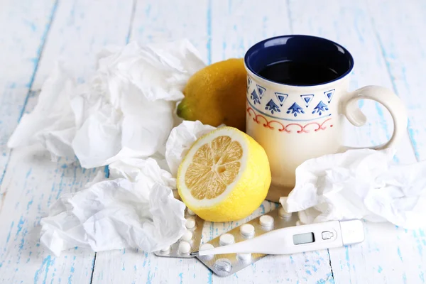 Té caliente para resfriados, píldoras y pañuelos en primer plano de la mesa — Foto de Stock