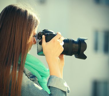 Young photographer taking photos outdoors clipart