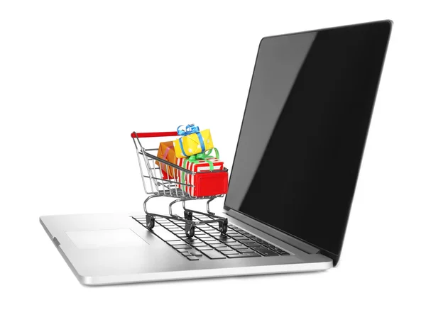 Laptop with small shopping cart full of gifts isolated on white background — Stock Photo, Image