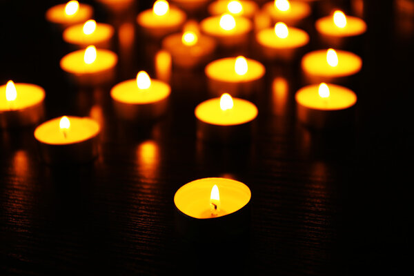 Burning candles on dark background