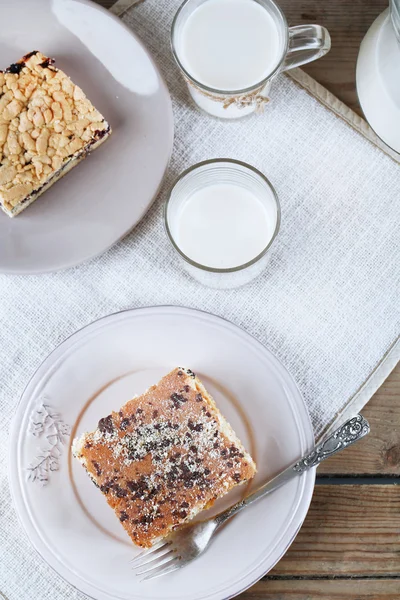 Zelfgemaakte taarten met jam en een glas melk op houten planken achtergrond — Stockfoto