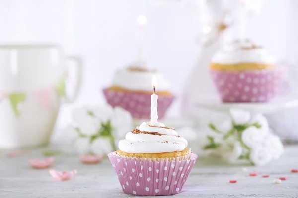 Delicious birthday cupcakes on table on light background — Stock Photo, Image