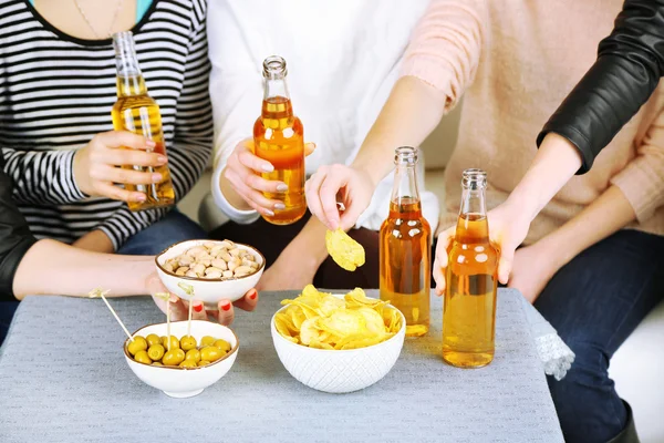 Friends hands with bottles of beer and snacks, close up — Stock Photo, Image