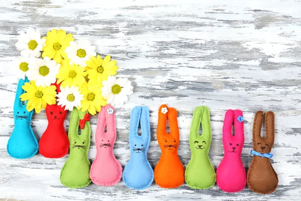 Composition with funny handmade Easter rabbits on wooden background — Stock Photo, Image