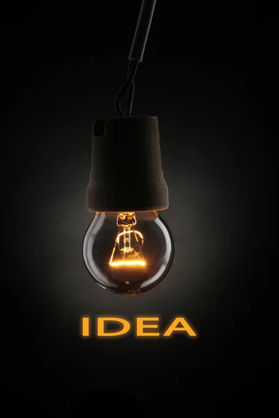 Light bulb on dark background — Stock Photo, Image